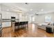 Open-concept living space with a modern kitchen, island seating, and a comfortable sofa area at 4976 Concert Ln, Marietta, GA 30066