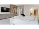 A bright main bedroom includes a wall-mounted TV, integrated storage, and entry to a spacious bathroom and walk-in closet at 4976 Concert Ln, Marietta, GA 30066
