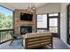 Inviting outdoor living space with a stone fireplace, comfortable seating, and scenic views at 4976 Concert Ln, Marietta, GA 30066