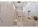A contemporary shower features marble tiling, bronze fixtures, built-in shelves, recessed lighting, and a convenient shower bench at 4976 Concert Ln, Marietta, GA 30066