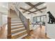View of a staircase with hardwood steps, custom iron railings, and an open living area at 4976 Concert Ln, Marietta, GA 30066