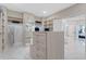 A luxurious walk-in closet boasts custom shelving, drawer space, mirrored dressing area, and entry to a large bathroom at 4976 Concert Ln, Marietta, GA 30066