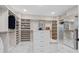 A spacious walk-in closet provides ample storage with custom shelving, integrated drawers, a seated bench, and mirrored dressing area at 4976 Concert Ln, Marietta, GA 30066