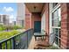 Balcony features a bistro table and chairs and overlooks a green cityscape at 77 Peachtree Ne # 507, Atlanta, GA 30309