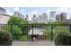 Balcony view of trees and city buildings in the background with blue skies at 77 Peachtree Ne # 507, Atlanta, GA 30309