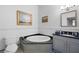 Bathroom featuring a granite countertop vanity and a corner soaking tub at 77 Peachtree Ne # 507, Atlanta, GA 30309