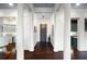 Inviting foyer with dark wood floors, white columns, and views of kitchen and living spaces at 77 Peachtree Ne # 507, Atlanta, GA 30309