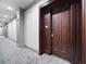 Well-lit hallway with neutral tones and carpet that leads to a solid wood entry door and unit number at 77 Peachtree Ne # 507, Atlanta, GA 30309