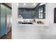 Well-appointed kitchen featuring blue cabinets, modern appliances, and a breakfast bar at 77 Peachtree Ne # 507, Atlanta, GA 30309