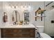This stylish bathroom features a double vanity, modern lighting, and a tiled shower with glass door at 1168 Eggleston Sw St, Atlanta, GA 30310