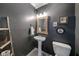 Charming powder room features a pedestal sink, decorative mirror, and rustic ladder towel rack at 1168 Eggleston Sw St, Atlanta, GA 30310