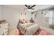 A modern bedroom featuring a ceiling fan, soft decor, and large windows at 1168 Eggleston Sw St, Atlanta, GA 30310