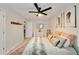 A neutral bedroom featuring ceiling fan, soft decor, and feather wall art at 1168 Eggleston Sw St, Atlanta, GA 30310