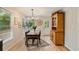 A brightly lit dining room area featuring hardwood floors and a vintage hutch at 1168 Eggleston Sw St, Atlanta, GA 30310