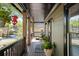 Inviting front porch with stylish decor, potted plants, and comfortable seating area at 1168 Eggleston Sw St, Atlanta, GA 30310