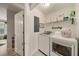 Bright laundry room with modern appliances, shelving, and natural light at 1168 Eggleston Sw St, Atlanta, GA 30310