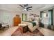 Bright main bedroom with tray ceiling, hardwood floors, a wooden chest, and many windows at 1168 Eggleston Sw St, Atlanta, GA 30310