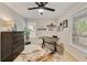 A sunny home office features neutral paint, modern ceiling fan, and decoratively appointed walls at 1168 Eggleston Sw St, Atlanta, GA 30310
