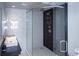 Bathroom featuring a modern glass shower and sleek black and white tiling at 2161 Peachtree Ne Rd # 605, Atlanta, GA 30309