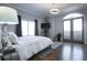 Bright bedroom with a large window, french doors, hardwood floors, and contemporary lighting at 2161 Peachtree Ne Rd # 605, Atlanta, GA 30309