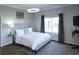 This bedroom features a comfortable bed, a modern chandelier, and a window with natural light at 2161 Peachtree Ne Rd # 605, Atlanta, GA 30309