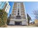 Low angle shot of the condo building with arched balconies, and a covered parking entrance at 2161 Peachtree Ne Rd # 605, Atlanta, GA 30309