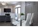 Dining area with glass-top table, seating for four, and a view into the living room at 2161 Peachtree Ne Rd # 605, Atlanta, GA 30309
