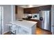 Modern kitchen with stainless steel appliances, white countertops, seating, and wood cabinets at 2161 Peachtree Ne Rd # 605, Atlanta, GA 30309