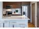 Modern kitchen with stainless steel appliances, sleek cabinets, and a breakfast bar with white countertop at 2161 Peachtree Ne Rd # 605, Atlanta, GA 30309