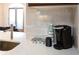 Kitchen area featuring a coffee station, light countertops, and stainless steel sink at 2161 Peachtree Ne Rd # 605, Atlanta, GA 30309