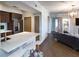 Open-concept living space featuring modern kitchen with counter seating, and hardwood flooring at 2161 Peachtree Ne Rd # 605, Atlanta, GA 30309
