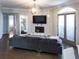 Cozy living room with fireplace, large sofa, and double doors leading to a terrace at 2161 Peachtree Ne Rd # 605, Atlanta, GA 30309