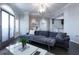 Inviting living room with a modern sofa, terrace access, and an open view to the kitchen at 2161 Peachtree Ne Rd # 605, Atlanta, GA 30309