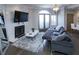 Elegant living room with fireplace, modern lighting, and a comfortable sofa on hardwood floors at 2161 Peachtree Ne Rd # 605, Atlanta, GA 30309