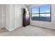 Carpeted bedroom features a dark wooden dresser and a well-lit closet next to the window at 3040 Peachtree Nw Rd # 511, Atlanta, GA 30305