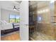 Bedroom showcasing ensuite bathroom, shower with custom tile work, and convenient shelving for toiletries at 3040 Peachtree Nw Rd # 511, Atlanta, GA 30305