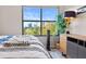 Bright bedroom with a large window offering city views, hardwood floors, and modern furniture at 3040 Peachtree Nw Rd # 511, Atlanta, GA 30305