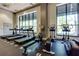 Modern fitness center with treadmills, elliptical machines, and floor-to-ceiling windows at 3040 Peachtree Nw Rd # 511, Atlanta, GA 30305