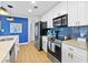 Modern kitchen with stainless steel appliances, white cabinets, subway tile backsplash, and wood-look flooring at 3040 Peachtree Nw Rd # 511, Atlanta, GA 30305