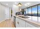 Well-lit kitchen with stainless steel appliances, white cabinets, breakfast bar, and view of the balcony at 3040 Peachtree Nw Rd # 511, Atlanta, GA 30305