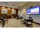An attractive lounge area featuring tables, chairs, kitchenette, and a large screen TV broadcasting financial market updates at 3040 Peachtree Nw Rd # 511, Atlanta, GA 30305