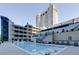Resort-style pool with in-water loungers, surrounded by lush landscaping and stunning building architecture at 3040 Peachtree Nw Rd # 511, Atlanta, GA 30305