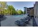 Beautiful community pool area with lounge chairs, lush landscaping, and modern building in the background at 3040 Peachtree Nw Rd # 511, Atlanta, GA 30305