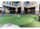A pristine putting green offers a recreational space for residents to practice their golf skills at 3040 Peachtree Nw Rd # 511, Atlanta, GA 30305