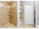 Elegant walk-in shower with custom tile work, a glass enclosure, and convenient shelving for toiletries at 3040 Peachtree Nw Rd # 511, Atlanta, GA 30305