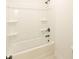 This bathroom features a shower and tub combination with built in shelving at 6565 Rhett Run, Cumming, GA 30028