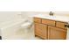 This bathroom features a vanity with modern fixtures, tiled floors, and a tub with shower at 6565 Rhett Run, Cumming, GA 30028