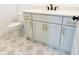 This bathroom features a modern vanity, stylish tile floors, and modern gold fixtures at 6565 Rhett Run, Cumming, GA 30028