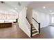 Bright foyer with hardwood floors, staircase, and kitchen area at 6565 Rhett Run, Cumming, GA 30028