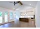 Elegant kitchen with large island, pendant lighting, stainless steel appliances, and open to living area at 6565 Rhett Run, Cumming, GA 30028